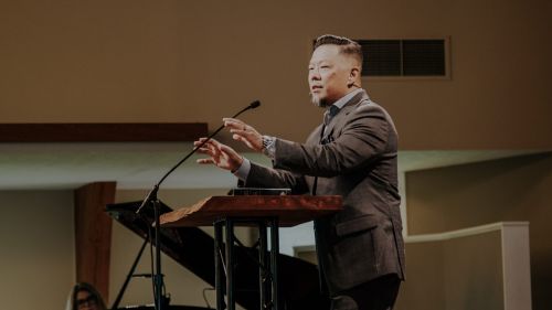 Photo of Pastor Phil Lien speaking with another church member