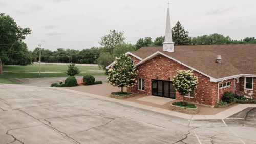 Photo of 3 people worshipping through song.