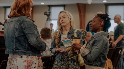 Photo of people singing in the congregation of a church service
