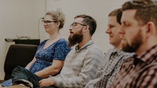 Photo of 4 people smiling and fellowshipping with each other